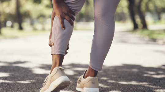 woman holding leg in pain due to dvt